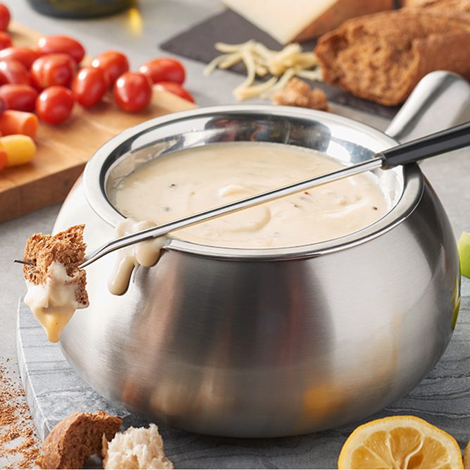 A bowl of cheese fondue on the table