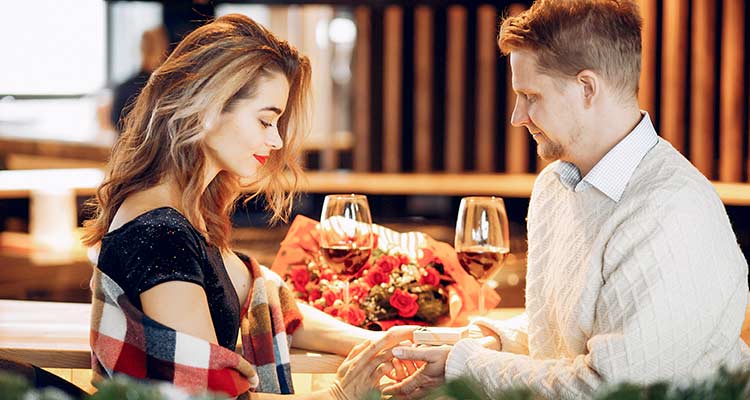 A man and woman are holding wine glasses.