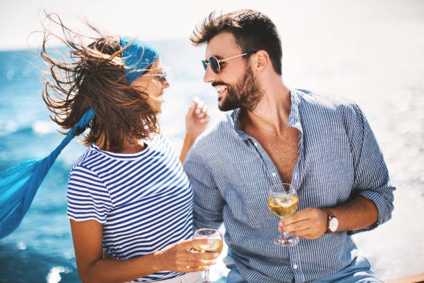 A man and woman are drinking wine outside.