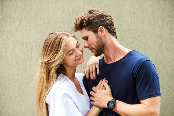 A man and woman are smiling for the camera.