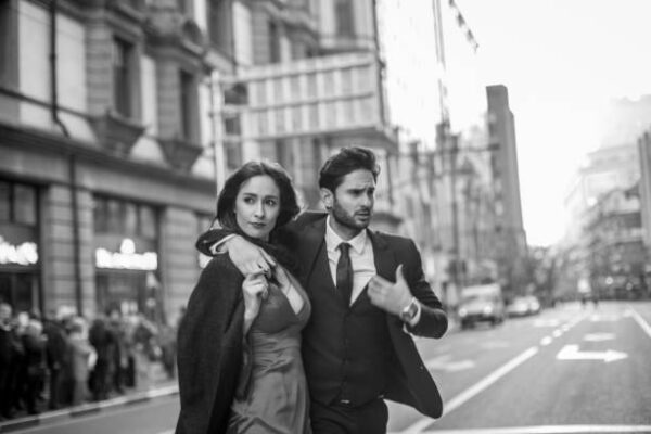 A man and woman walking down the street.