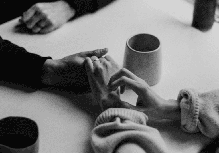 A group of people sitting around a table with coffee.