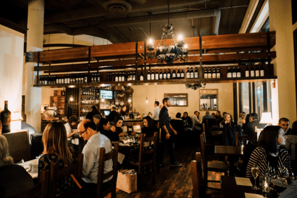 A group of people sitting at tables in a restaurant.